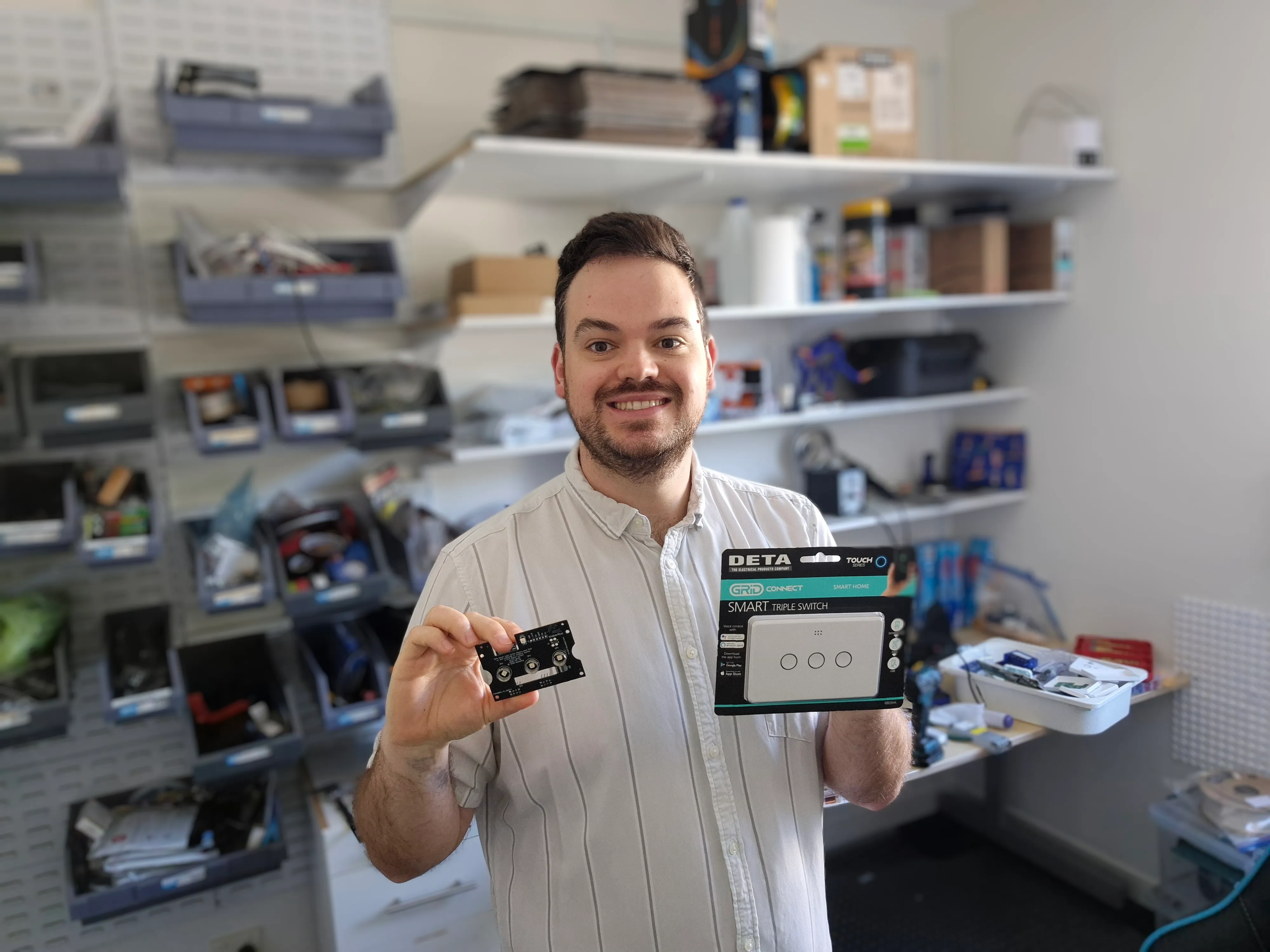 Sam holding up product in the study/workshop room